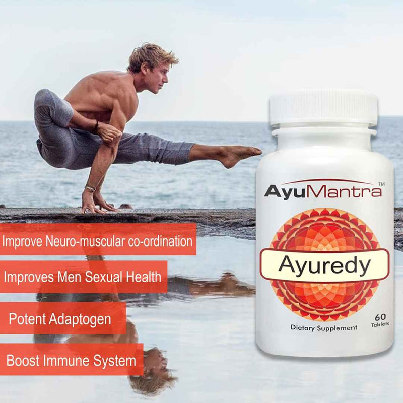 Man doing yoga pose by the sea with Ayuredy tablets bottle highlighting strength and immune support.