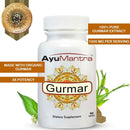 AyuMantra gurmar tablet bottle with organic extract badge, leaves, and herb powder.