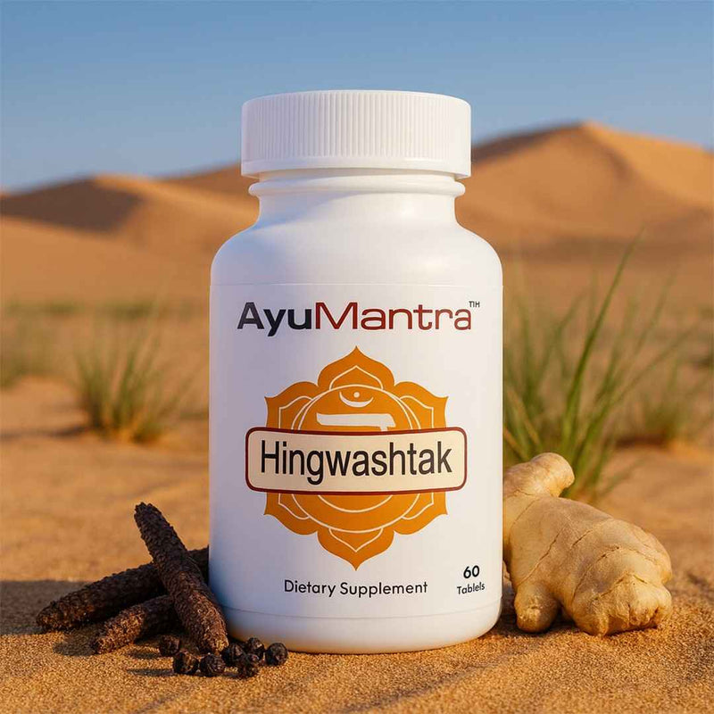 AyuMantra Hingwashtak tablets bottle with ginger and long pepper in desert sand, Ayurvedic digestion supplement.