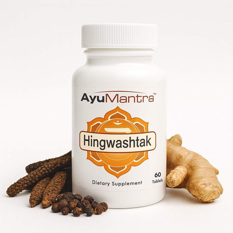 AyuMantra Hingwashtak tablets bottle with ginger, long pepper and black pepper on white background digestion support.