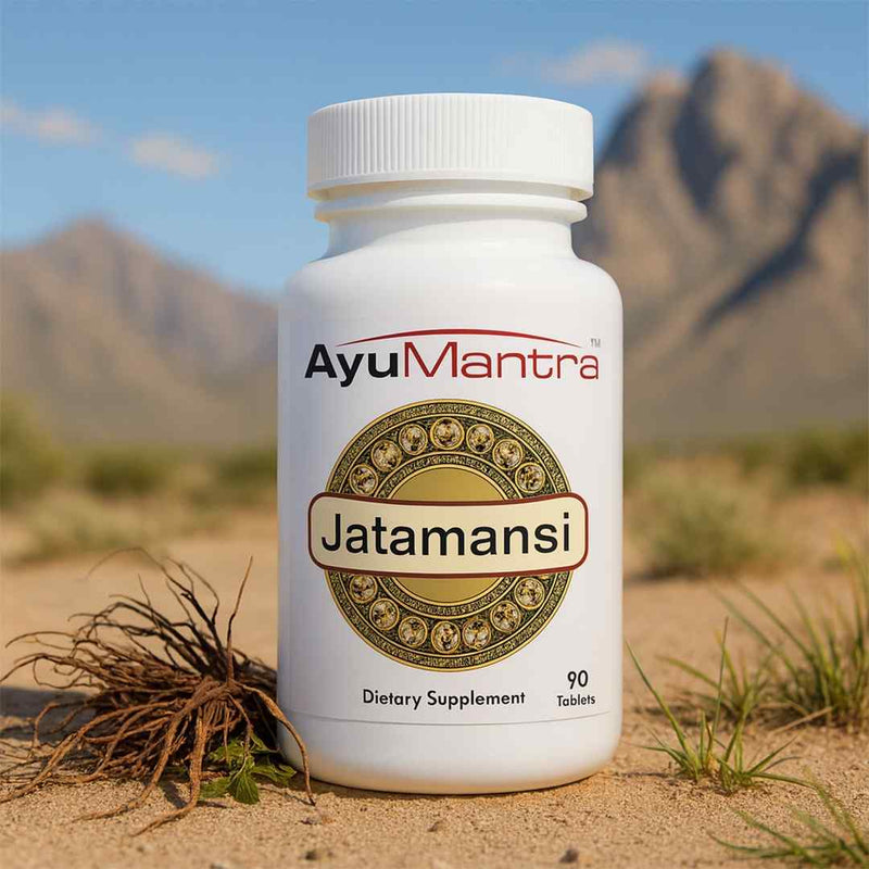 Ayumantra Jatamansi tablets bottle on sandy ground with jatamansi root and mountain desert background.