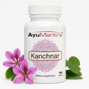 Kanchnar tablets bottle on white background with pink flowers and green leaves, AyuMantra herbal tablets