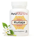 AyuMantra Kutaja tablet bottle with fresh kutaja leaves and white flowers on a clean white background.