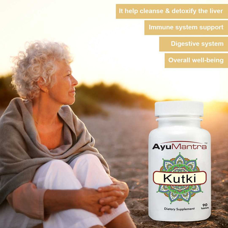 Woman sitting outdoors with AyuMantra Kutki supplement bottle