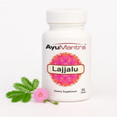 AyuMantra Lajjalu dietary supplement bottle with leaves and flower on a white background