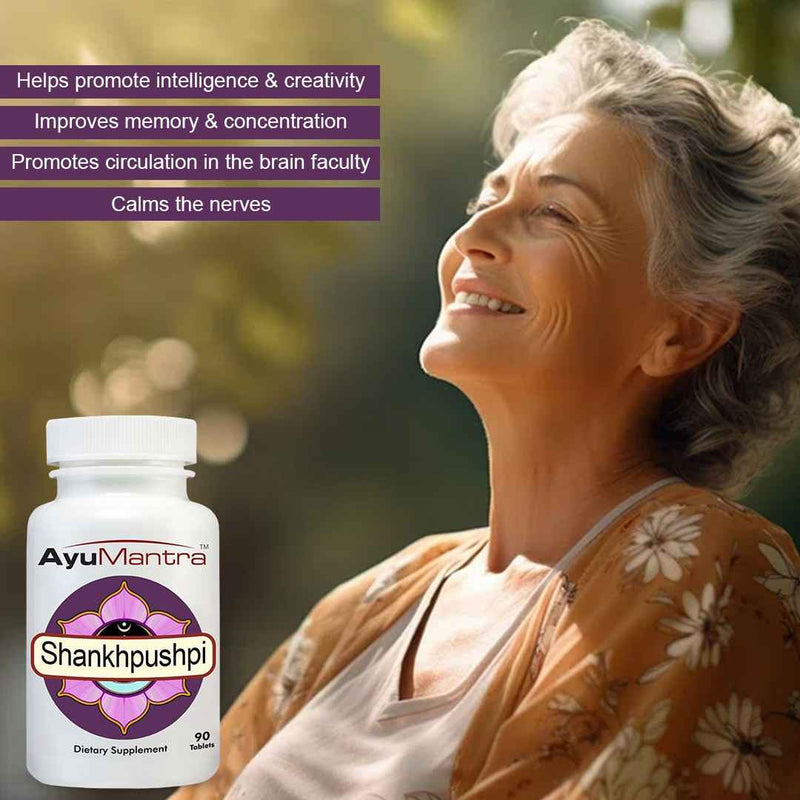 Woman with a bottle of AyuMantra Shankhpushpi supplement against a blurred natural background